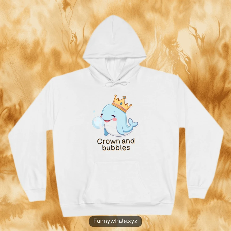 Smiling whale wearing a crown, blowing a large, sparkly bubble, featured on a soft and warm hoodie.