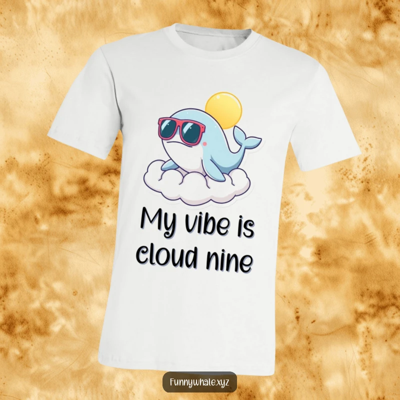 Funny whale character in oversized sunglasses lounging on a sunny cloud, radiating cool vacation vibes on this humorous t-shirt.